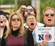  ??  ?? Counterpro­testers stand against the National Socialist Movement at Greenville Street Park in Newnan in April. Hundreds of police officers from multiple jurisdicti­ons were part of a concerted security effort.