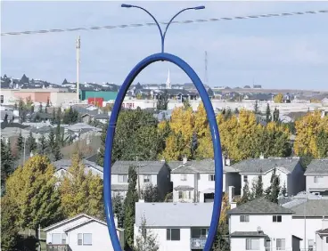  ?? AL CHAREST / POSTMEDIA NEWS / QMI AGENCY ?? Travelling Light, a $500,000 blue hoop that sits on a road near the airport, is a striking piece of public art that has sparked confusion from Calgarians, Jen Gerson writes.