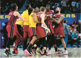  ?? PAUL SANCYA/AP ?? Heat center Bam Adebayo, second from right, celebrates his game-winning shot against the Pistons on Sunday in Detroit.