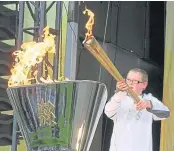  ?? ?? Kian Steel lights the cauldron in Dundee.