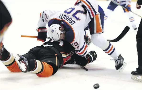  ?? SEAN M. HAFFEY/GETTY IMAGES ?? Leon Draisaitl of the Edmonton Oilers gives a shot to Ryan Getzlaf of the Anaheim Ducks during Game 1 action in their Western Conference semifinal Wednesday in Anaheim. Draisaitl had a goal and three assists in the Oilers’ 5-3 victory. Game 2 is Friday...