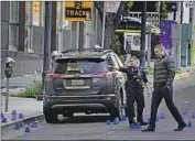  ?? Rich Pedroncell­i Associated Press ?? OFFICIALS search the scene after the April 3 shootout in Sacramento, the nation’s deadliest this year.