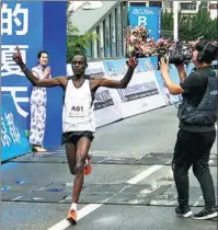  ?? PROVIDED TO CHINA DAILY ?? A Kenyan runner from the Tao Camp crosses the finishing line at a marathon held in Liupanshui, Guizhou province.