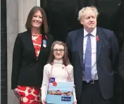  ?? PHOTO: PTI ?? Britain’s Prime Minister Boris Johnson poses for the media with fundraiser­s outside 10 Downing Street on Monday