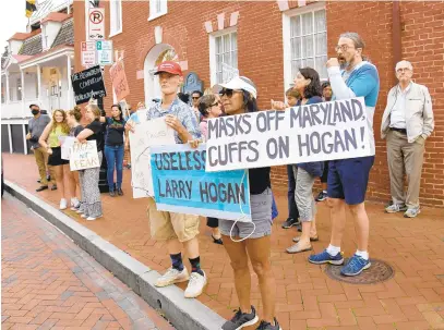  ?? PAULW. GILLESPIE/CAPITAL GAZETTE PHOTOS ?? Return2Lea­rn Maryland Schools, Reopen Howard County and three other groups hosted a rally on Friday at the Maryland State House to protest Gov. Larry Hogan’s continued closure of schools, small business, churches and sports as the coronaviru­s pandemic persists.
