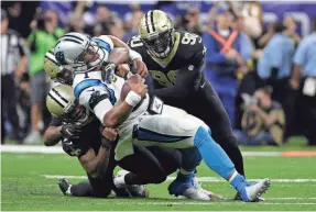  ??  ?? Defensive end Cameron Jordan, bottom left, played a big role in the Saints’ victory against Carolina on Sunday.