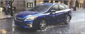  ?? Associated Press photo ?? This photo provided by Subaru shows the 2017 Subaru Legacy, which comes with standard all-wheel drive. In snowy, slushy or rainy winter conditions, all-wheel drive helps a vehicle accelerate better and maintains its traction on slick surfaces.