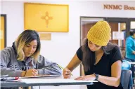  ?? NICK SANCHEZ/FOR THE NEW MEXICAN ?? Britney Castillo and Karla Dominguez create Women’s March signs during Friday’s poster-making party at Northern New Mexico College in Española.