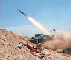  ??  ?? Iraqi government forces fire a rocket Thursday in a major assault to retake the Fallujah area from the Islamic State group.