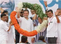  ??  ?? Rahul Gandhi being garlanded by party leaders during a ‘direct dialogue’ with supporters of the party in Ahmedabad. —