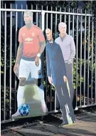  ??  ?? Three’s a crowd: Cardboard cut-outs of Paul Pogba, Zinedine Zidane and Jose Mourinho outside Old Trafford