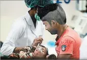  ?? SANJAY KANOJIA/GETTY-AFP ?? A child is treated for encephalit­is Saturday at the Baba Raghav Das Medical College Hospital in Gorakhpur, India.