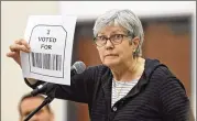  ?? BOB ANDRES / BANDRES@AJC.COM ?? Susan McWethy, from Decatur, speaks against a voting system that combines touchscree­ns and printedout paper ballots that use bar codes during a public comment period on Aug. 30.