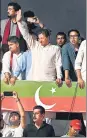  ?? AFP ?? Ousted prime minister Imran Khan (centre) waves from atop a bus at a rally in Islamabad.