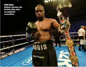  ??  ?? NEW KING: Dubois clutches the British title after an emphatic coronation