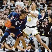  ?? Mark Stockwell/Associated Press ?? UConn’s Stephon Castle (5) looks to drive against Providence’s Rafael Castro during the first half on Saturday.