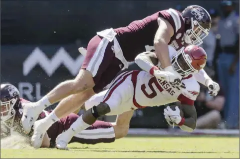  ?? (NWA Democrat-Gazette/Charlie Kaijo) ?? Arkansas running back Raheim Sanders (5) is brought down during last Saturday’s loss against Mississipp­i State at Starkville, Miss. The Razorbacks’ running game was stopped twice inside the Bulldogs’ 10-yard line in short-yardage situations.