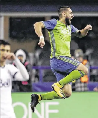  ?? ELAINE THOMPSON / ASSOCIATED PRESS ?? Seattle Sounders forward Clint Dempsey leaps after scoring the first of his two goals against the Vancouver Whitecaps in Seattle’s win Thursday night.