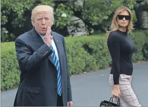  ?? AP PHOTO ?? U.S. President Donald Trump stops briefly in front of reporters as he and first lady Melania Trump walk to Marine One on the South Lawn of the White House in Washington, Wednesday. The Trumps are heading to Poland and then Germany for the G20.