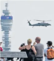  ??  ?? Mr Trump and Mrs May hold hands briefly at Blenheim, left. Above, the president’s helicopter draws attention over London