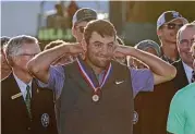  ?? Streeter Lecka / Getty Images ?? Scottie Scheffler of Texas is awarded a medal after finishing as the low amateur during the final round of the U.S. Open at Erin Hills Sunday.