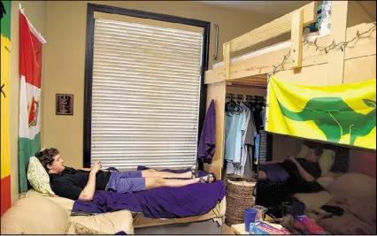  ?? BRANT SANDERLIN / AJC ?? Georgia Tech student Clark Jacobs hangs out in his room at the Kappa Sigma fraternity house Thursday. Jacobs cracked his skull in January 2015 when he fell out of his loft bed. Jacobs and his family have started a public awareness campaign to install...