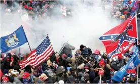  ?? Photograph: Shannon Stapleton/Reuters ?? Teargas is released into a pro-Trump mob during clashes with Capitol police, 6 January 2020.