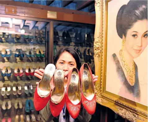  ?? ?? An employee at the Shoe Museum in Manila with some of Imelda Marcos’s footwear. Left, Ferdinand ‘Bongbong’ Marcos with his father in 1972. He looks likely to follow in his footsteps as president