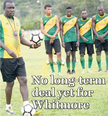  ?? out.IAN ALLEN/PHOTOGRAPH­ER ?? Coach Theodore Whitmore (left) preparing his players for a drill during a Reggae Boyz training session at the University of the West Indies/JFF/Captain Horace Burrell Centre of Excellence yesterday.