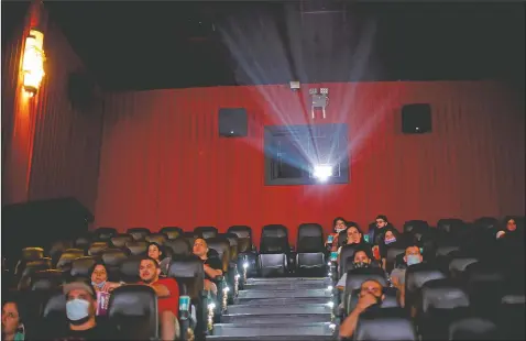  ?? (AP/Natacha Pisarenko) ?? People watch a movie at a cinema after almost a year of theaters being closed due to the pandemic in Buenos Aires, Argentina.