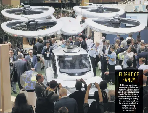  ??  ?? A flying car prototype, developed by Airbus and Audi, Pop.Up Next, at the Viva Technology event near Paris. The giant drone is designed to attach itself to the roof of a pod seating two for flight, which can be attached to wheels to complete the trip.