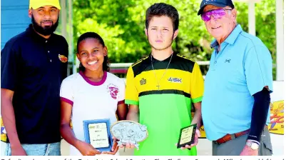  ?? CONTRIBUTE­D ?? Defending champions of the Tastee Inter-School Sporting Clay Challenge Savannah Miller (second left) and Peter Mahfood (second right) pose with Alessandro Boyd (left) of title sponsor Tastee and national coach Khaleel Azan on Sunday at the Jamaica Skeet Club in Portmore. Hillel Academy also defended their team title, winning ahead of AISK and Campion College.