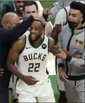  ?? Paul Sancya The Associated Press ?? Khris Middleton celebrates with Bucks teammates during Game 4 of the NBA Finals at Fiserv Forum on Wednesday.