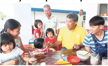  ??  ?? Meet and greet: Mohamad visiting the Rantau wet market to thank the voters after he won the by-election.