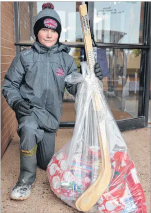  ?? COLIN MACLEAN/JOURNAL PIONEER ?? Greenfield Elementary School student Max Clark is one of a number of students at the school who spent some of their own savings to help with the annual Christmas hampers campaign. Greenfield has partnered with the St. Eleanors Lions Club to sponsor 15...