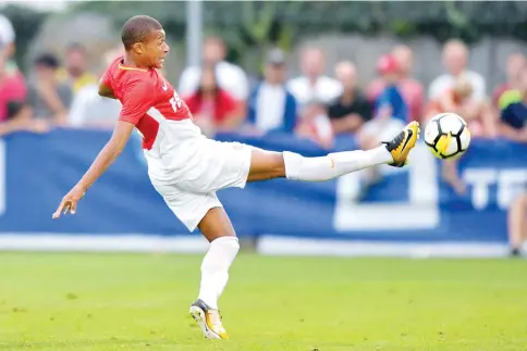  ?? — AFP photo ?? Monaco’s French forward Kylian Mbappe reaches out to the ball during a friendly football game between AS Monaco and Fenerbahce SK on July 19, 2017 in Montreux.