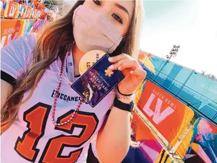  ?? COURTESY OF LAUREN GUINN ?? Lauren Guinn, a Los Lunas High grad, sports a Tom Brady jersey and shows off her health care worker credential while attending the Super Bowl on Sunday: “A once-in-a-lifetime experience for sure.”