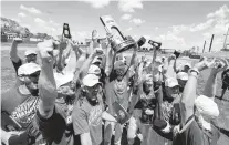  ?? JACK DEMPSEY/GETTY ?? Members of Salisbury celebrate a win against St. Thomas during the Division III men’s baseball Championsh­ip on Tuesday in Cedar Rapids, Iowa.