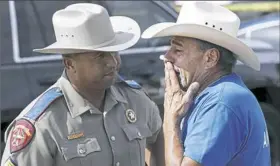  ?? Eric Gay/Associated Press ?? Rene Moreno holds back tears as he speaks with a Texas state trooper Tuesday outside the First Baptist Church of Sutherland Springs.