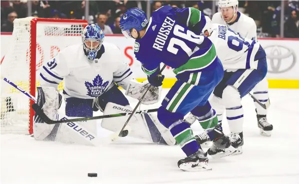  ?? — USA TODAY SPORTS ?? The Canucks’ Antoine Roussel shoots against Leafs goalie Frederik Andersen in the first period of Tuesday’s game at Rogers Arena.