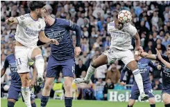  ?? | SERGIO PEREZ EPA ?? RODRYGO rises high to head in the equaliser for Real Madrid against Manchester City on Wednesday.