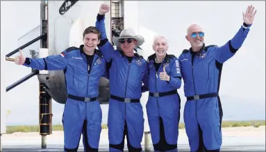  ?? Joe Raedle / Getty Images ?? Blue Origin’s New Shepard crew, from left, Oliver Daemen, Jeff Bezos, Wally Funk and Mark Bezos pose near the booster after flying into space in the Blue Origin New Shepard rocket on July 20 in Van Horn, Texas.