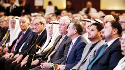  ??  ?? US Secretary of State Rex Tillerson, center, with other participan­ts at the Internatio­nal Conference for Reconstruc­tion of Iraq, in Kuwait City on Tuesday. (AFP)