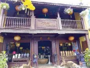  ??  ?? A shop in the old town of Hoi An. Lovely 200-to 300-year-old timber frame buildings line the three main streets of the old town, with stores that sell silk clothes and scarves, silver jewelry, gems.