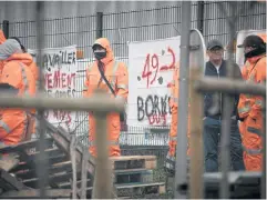  ?? AFP ?? Union members gather at an entrance to the CETCO cleaning services centre, during a strike action near Le Havre, northweste­rn France on Monday.