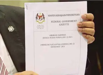  ?? PIC BY MOHD FADLI HAMZAH ?? Minister in the Prime Minister's Department (Parliament and Law) Datuk Seri Takiyuddin Hassan showing the government gazette of the new ‘fake news’ law yesterday.