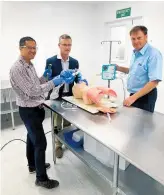  ??  ?? Waikato emergency doctors Giles Chanwai and Martyn Harvey work with plastics engineer Jeff Sharp.