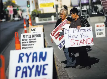  ?? Chase Stevens ?? Las Vegas Review-journal @csstevensp­hoto Lillie Spencer, left, and Margaret Houston hold signs supporting the Bundy family and other Bunkervill­e standoff defendants outside the Lloyd George U.S. Courthouse on Tuesday.