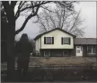  ?? STACEY WESCOTT/CHICAGO TRIBUNE VIA AP ?? A man stands and looks at the home in Bolingbroo­k, Ill., on Monday, where three people were fatally shot, and another person was wounded Sunday night.