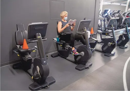  ?? ADOLPHE PIERRE-LOUIS/JOURNAL ?? Cheri Sanger pedals a stationary bike at the Jewish Community Center gym Wednesday.